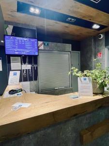 a wooden counter with two signs on top of it at ibis budget Compiègne Centre-Ville in Compiègne