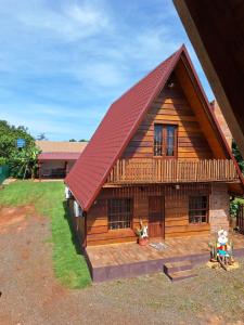 a log cabin with a red roof at Fi-Scheer Bungalows in Bella Vista
