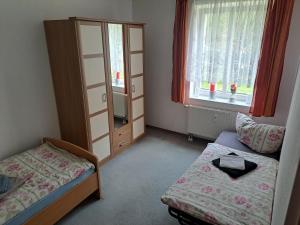 a room with a bed and a dresser and a bedroom at 2 Raum Zwickau Privat in Zwickau