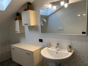a bathroom with a sink and a mirror at RosaMarina 227 in Cavallino-Treporti
