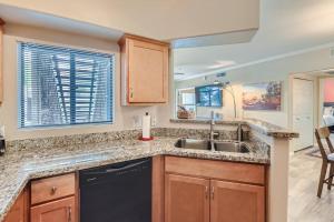 a kitchen with wooden cabinets and a sink at 2bd/1ba North Scottsdale Condo in Scottsdale