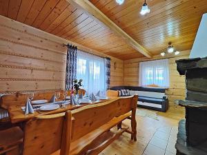 a dining room with a large wooden table in a cabin at Domki na Wzgórzu in Piekielnik