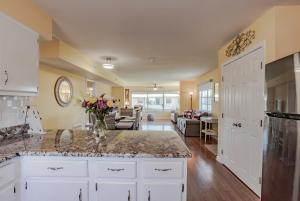 a kitchen with a counter top and a living room at Stylish Condo with a view of the water in Dauphin Island