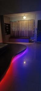 a dance floor with purple and red lights in a room at perdana homestay in Ipoh