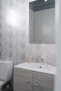 ein Badezimmer mit einem weißen Waschbecken und einem WC in der Unterkunft Orsiida classic double room Volos in Volos