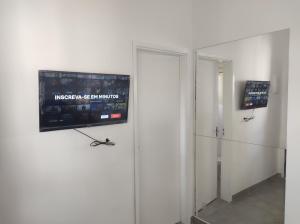 a room with a flat screen tv on a wall at Casa Cardoso in Bertioga +15 photos