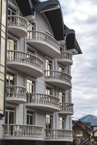 a building with balconies on the side of it at Olimp Hotel in Bukovel