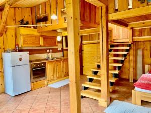 a kitchen with wooden cabinets and a white refrigerator at Dovolenkový dom Ela pets friendly in Poprad