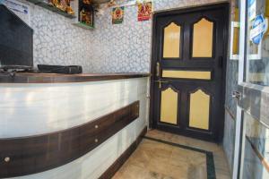 a bar with a black door in a room at Anirudha Guest House in Digha