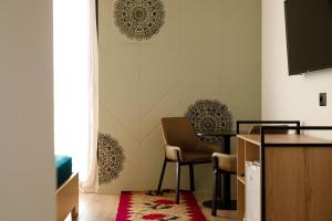 a living room with a table and two chairs at The Barrels Ms in Gjirokastër +45 photos