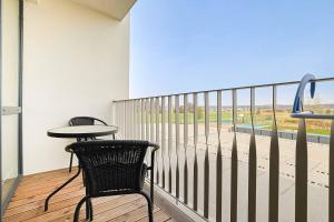 a balcony with a table and two chairs and a view at Studio W/Balcony @ManoŠventovė, By Cohost in Palanga