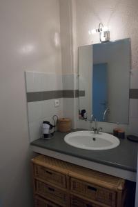 a bathroom with a sink and a mirror at La vallée de Gaïa in Saint-Hilaire-de-Lavit