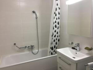 a bathroom with a tub and a sink and a shower at Modern apartment easy commute, Geneva & Nyon 75m2 in Founex