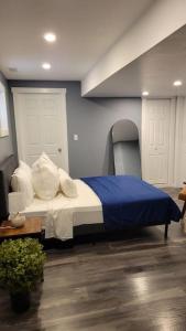 a bedroom with a bed with blue and white pillows at Beautiful newly designed Luxurious Apartment in Windsor