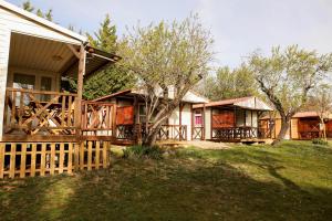 a house with a porch and a fence at Camping Castillo de Loarre in Loarre