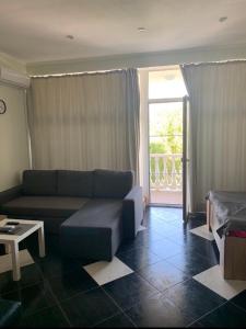 a living room with a couch and a window at Apartments ZOLOTOY BEREG in Zatoka