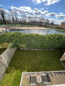 an overhead view of a garden with two tables in the grass at Hampton Court Cottage in Hampton