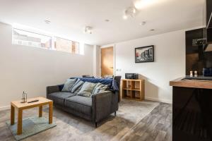 a living room with a couch and a table at Cosy 1 Bedroom Apartment in Central Sheffield in Sheffield