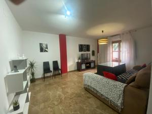 a living room with a couch and a table at La Casa Del Buda in Güéjar-Sierra