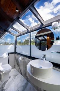 a bathroom with a sink and a toilet at FIKA Residence in Dois Irmãos