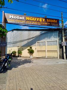 a building with a hotel norwegianillian sign on it at NGUYỆT MINH HOTEL in Ấp Phú Lợi