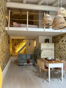 a living room with a loft bed and a table at Casa castello in Rocca Imperiale