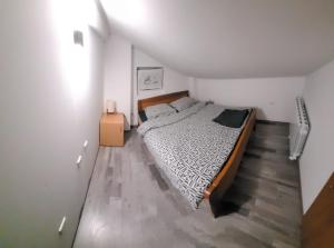 a bedroom with a large bed in a attic at Holiday House Tina in Čabar