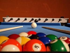 a pool table with billiard balls and cue sticks at Holiday House Tina in Čabar