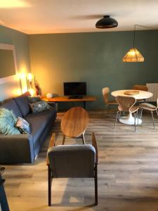 a living room with a couch and a table at Appartement Rez de Jardin in Cavalaire-sur-Mer