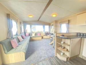 a living room with a couch and a table at Caravan in morecombe in Morecambe