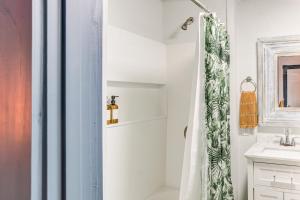 a bathroom with a shower curtain and a sink at Charming Minneapolis Home with Deck, 5 Mi to Central in Minneapolis +19 photos