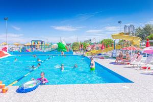 a group of people in a pool at a water park at Hotel Altamarea Cesenatico in Cesenatico