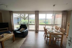 a living room with a table and a couch at Ferienhaus direkt an der Hase in Quakenbrück