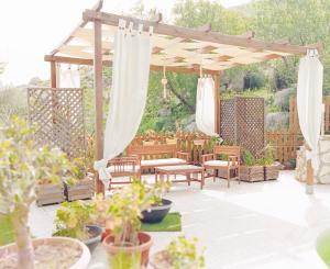a patio with a gazebo and potted plants at Appartamento•Palermo in Torretta