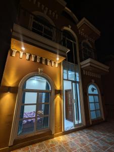 a building with a large window on the side of it at Central Residence in Gujrānwāla