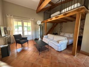 a living room with a couch and a loft bed at Hostellerie Le Roy Soleil in Ménerbes