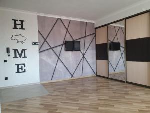Cette chambre dispose d'un mur et d'une télévision. dans l'établissement Apartment na Shashkevicha 16, à Trouskavets