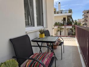 a balcony with a table and chairs on a balcony at Navaro Apartments in Patra