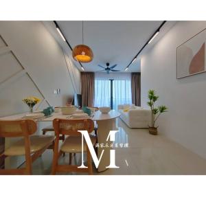 a living room with a table and chairs and a couch at Setia Alam Walking Distance Convention Centre 2 Bedroom 2-4Pax in Shah Alam