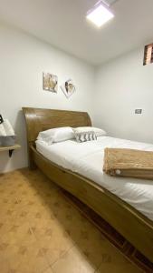 1 dormitorio con 1 cama con cabecero de madera en REST APARTMENT IN THE POBLADO, en Medellín