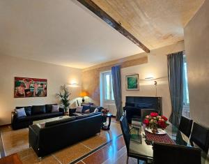 a living room with a couch and a table at Vatican Prestige - Meospiti Cesare Exclusive in Rome