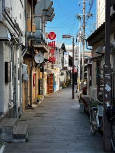 an empty street in a city with buildings at Guesthouse Azumaya in Matsumoto