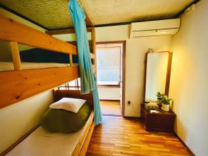 Postel nebo postele na pokoji v ubytování Guesthouse Azumaya