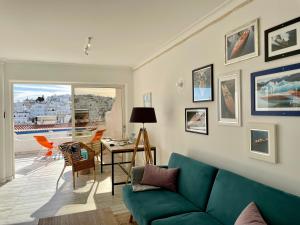 a living room with a green couch and a table at Ocean Balcony apartment terrace sea view and pool in Albufeira +26 photos