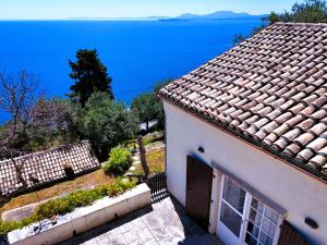 a white house with a view of the ocean at Tsoupis Farm House in Agní