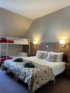 a hotel room with two beds and a bunk bed at Fairburn Activity Centre in Contin