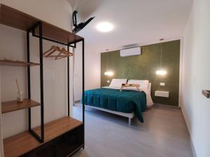 a bedroom with a bed with a green blanket at Casa Semeria Certosa di Padula(SA) in Padula