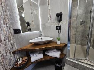a bathroom with a sink and a shower at Casa Semeria Certosa di Padula(SA) in Padula