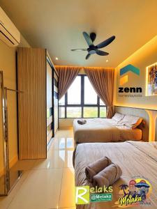 a bedroom with two beds and a ceiling fan at The Bali Residences Premium Suites Melaka in Melaka