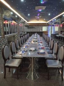 a long dining room with a long table and chairs at Venus Resort & Coffee House in Bāndarban